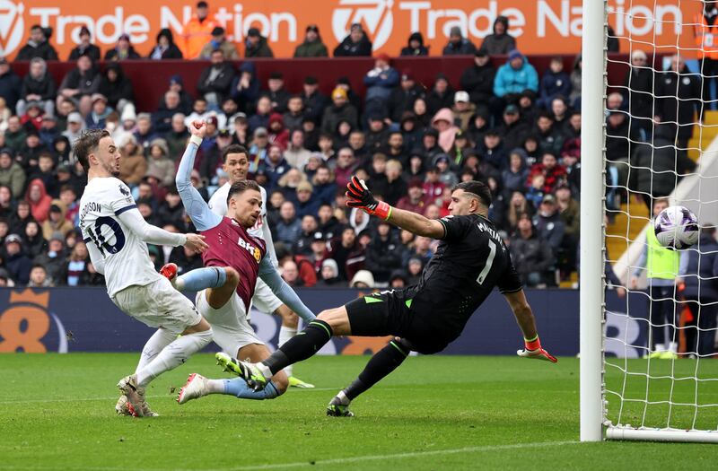 Tottenham Hotspur's James Maddison scores their first goal past Aston Villa's Emiliano Martinez. Reuters