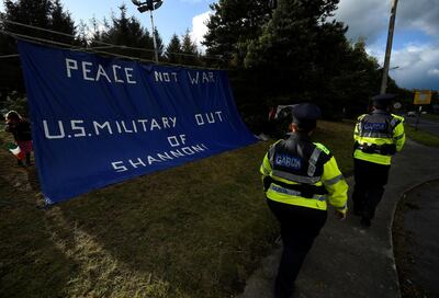 Irish police officers pass by an anti-U.S. President Donald Trump sign as people demonstrate in a camp they have set up outside Shannon Airport in Shannon, Ireland, June 5, 2019. REUTERS/Clodagh Kilcoyne