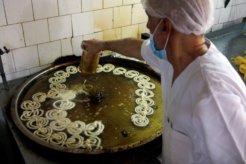 A worker prepares traditional sweets for sale during Ramadan at a shop in Iraq's capital Baghdad. Reuters