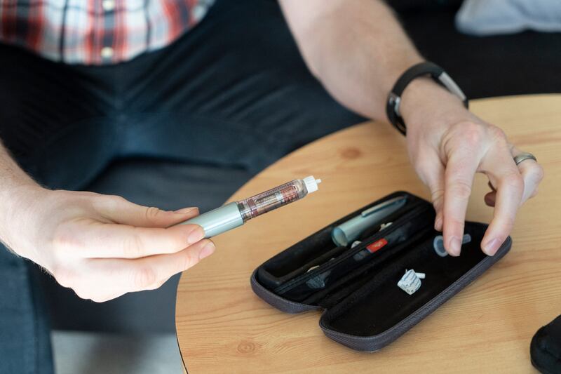 A diabetes sufferer prepares an insulin injection. AFP