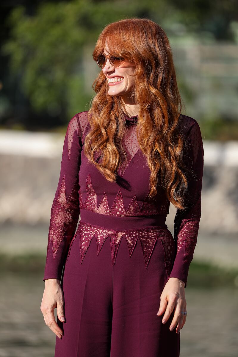 Actress Jessica Chastain wore a plum lace-insert jumpsuit by Zuhair Murad as she arrived at the 78th Venice International Film Festival on September 5, 2021. Getty Images