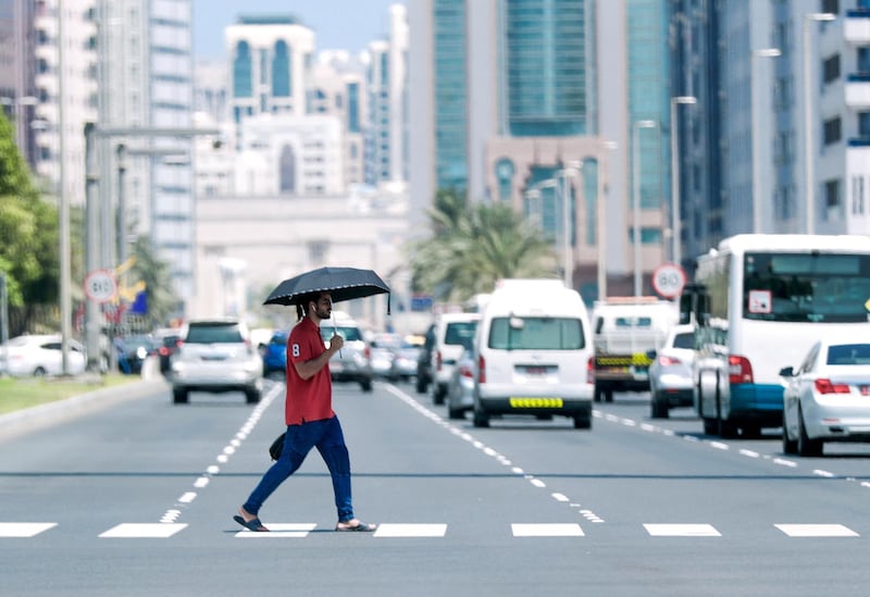 Abu Dhabi, United Arab Emirates, July 15, 2019.  Standalone weather images.   A pedestrian crosses the street on Sultan Bin Zayed the first Street.
Victor Besa/The National
Section:  NA
Reporter: