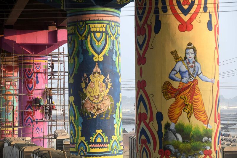 Indian artists paint pillars of the Shastri bridge over the Ganges  in Allahabad. AFP