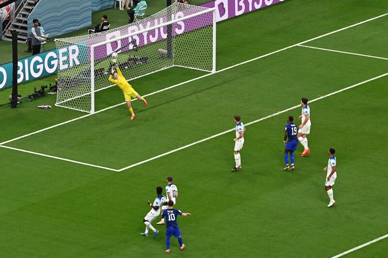 England goalkeeper Jordan Pickford cannot stop Christian Pulisic's shot hitting the crossbar. AFP