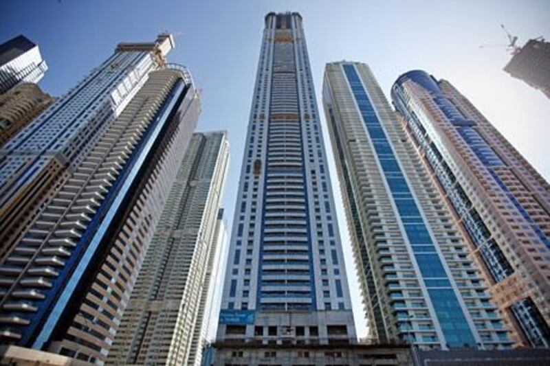 United Arab Emirates - Dubai - January 3, 2011.

BUSINESS: Construction crews work on skyscrapers dotting the north end of the Dubai Marina on Monday, January 3, 2011. At center is the Tameer Holding Investments company's "Princess Tower." Amy Leang/The National