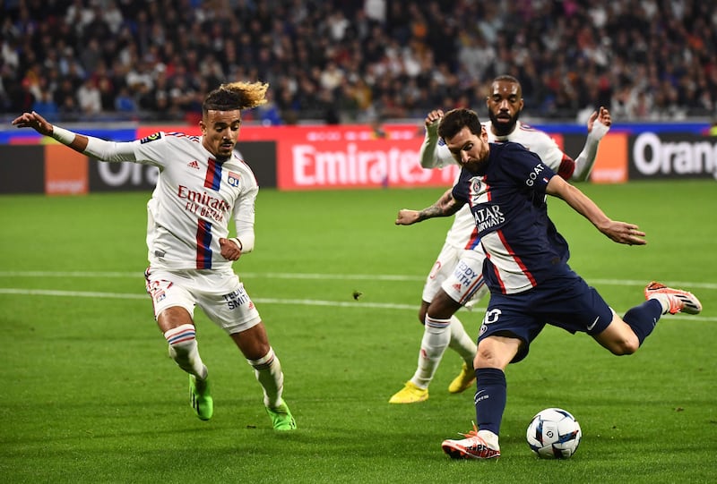 Lionel Messi takes a shot under pressure from Lyon's French defender Malo Gusto. AFP