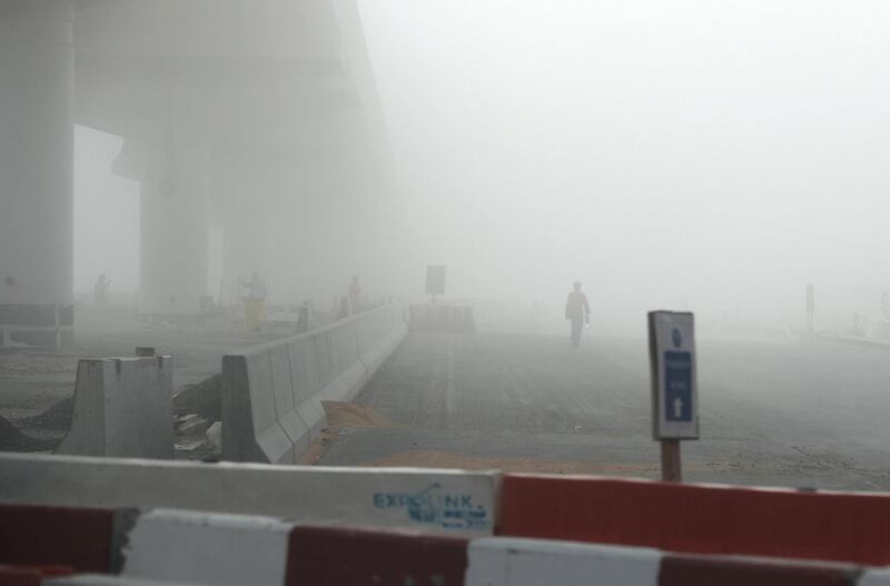 DUBAI, UNITED ARAB EMIRATES , Feb 16  – 2020 :-  Workers working at the EXPO 2020 metro line during the early morning fog in Discovery Gardens and Al Furjan area in Dubai.  (Pawan  Singh / The National) For News/Online/Instagram. 