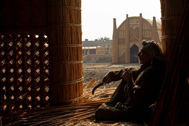 A man sits at the entrance of a mudhif reed house, along Iraq's southern Chibayish marshes in Dhi Qar province. AFP