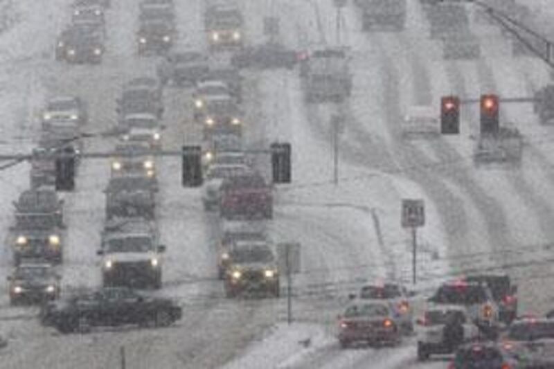 Vehicles travel in blizzard conditions on Dodge Street in Omaha, Nebraska, yesterday.