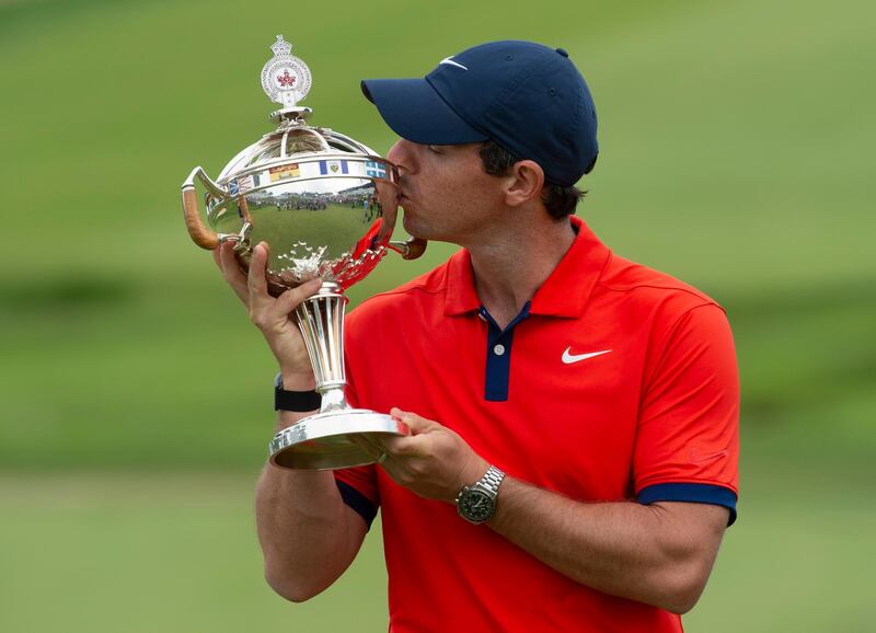 Rory McIlroy kisses the trophy after winning the Canadian Open golf championship in Ancaster, Ontario, Sunday, June 9, 2019. (Adrian Wyld/The Canadian Press via AP)