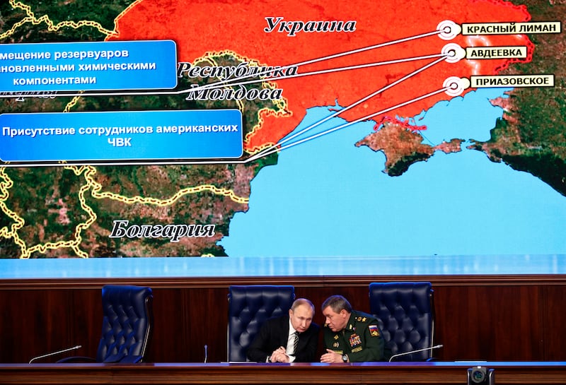 Russian President Vladimir Putin and Gen Valery Gerasimov speak during a meeting of the Russian Defence Ministry Board, with a Russian military map showing the reported deployment of US private military contractors in eastern Ukraine. AP