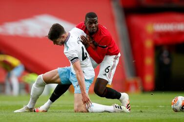 West Ham United's Declan Rice (left) and Manchester United's Paul Pogba battle for the ball during the Premier League match at Old Trafford, Manchester. PA Photo. Picture date: Wednesday July 22, 2020. See PA story SOCCER Man Utd. Photo credit should read: Clive Brunskill/NMC Pool/PA Wire. RESTRICTIONS: EDITORIAL USE ONLY No use with unauthorised audio, video, data, fixture lists, club/league logos or "live" services. Online in-match use limited to 120 images, no video emulation. No use in betting, games or single club/league/player publications.