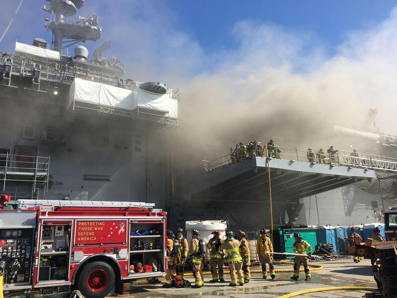 Firefighters combating a blaze aboard the amphibious assault ship' USS Bonhomme Richard' at the naval base in San Diego. AFP