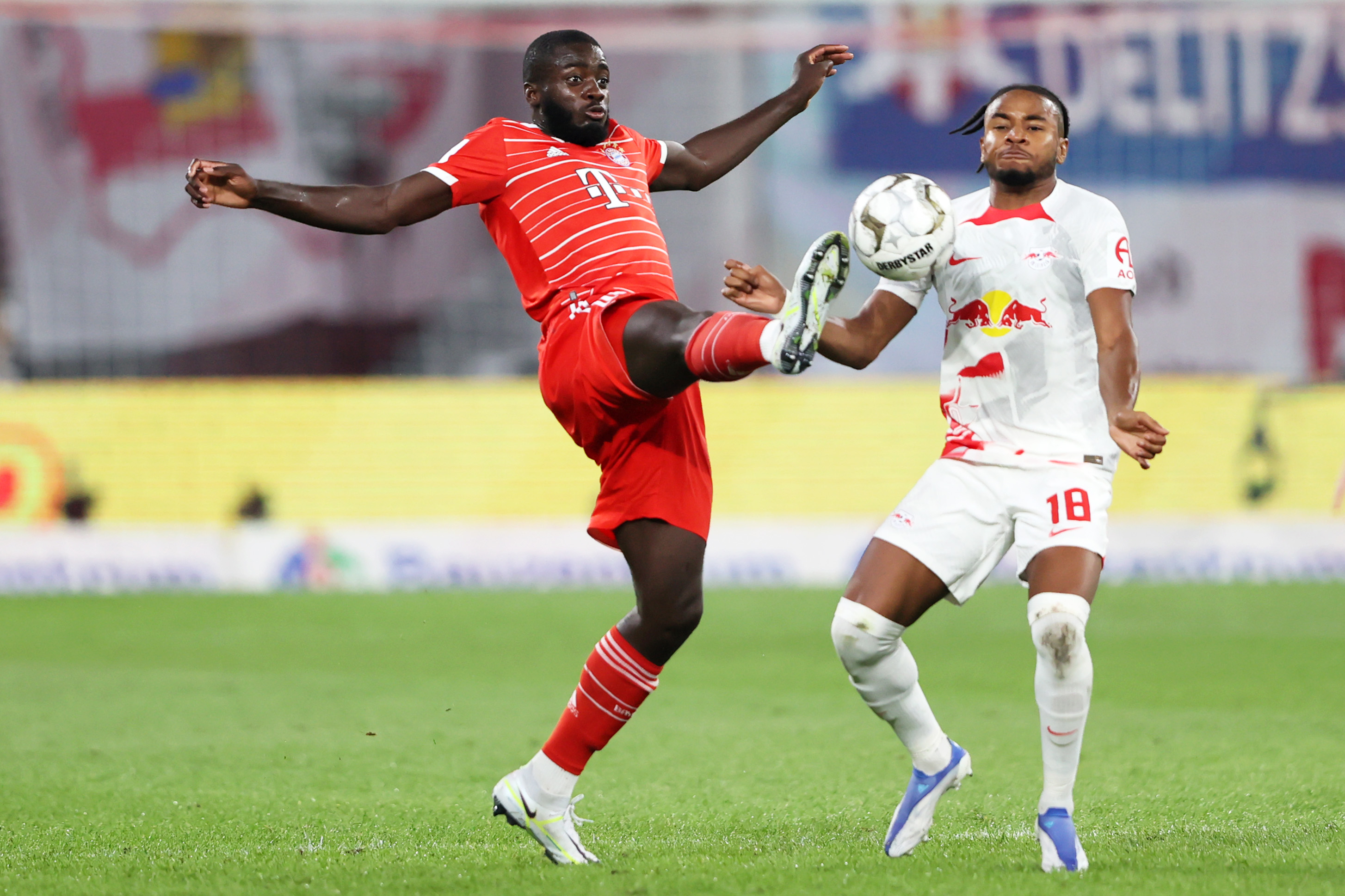 Dayot Upamecano of Bayern Munich is challenged by Christopher Nkunku of RB Leipzig. Getty Images