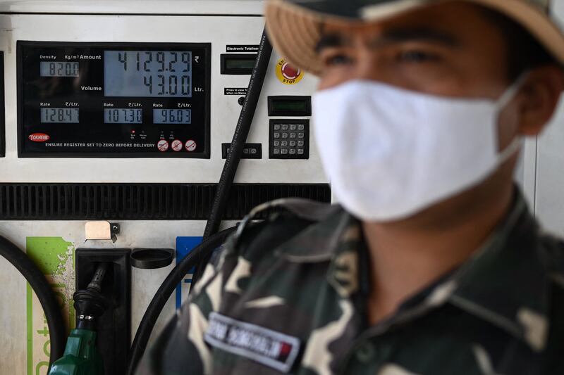 A security guard at a petrol station during protests by activists demonstrating against the recent price hike of fuel and diesel, in India's capital New Delhi. AFP