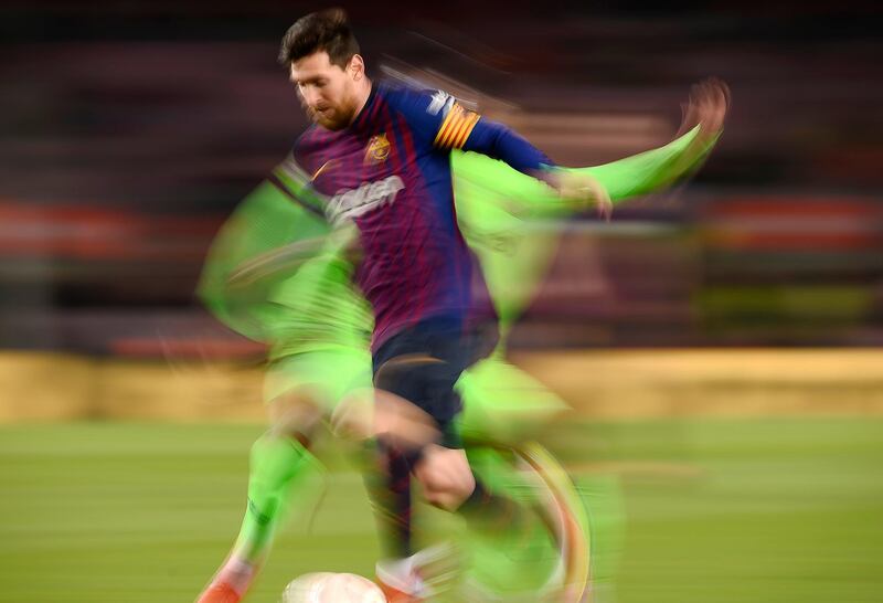 Barcelona's Argentinian forward Lionel Messi vies with a member of Levante UD at the Camp Nou stadium in Spain. AFP