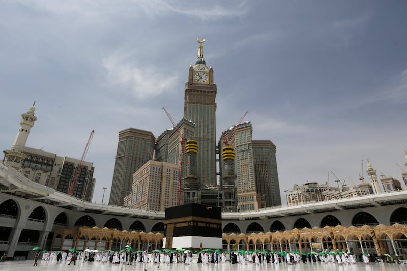 Muslim pilgrims walk around the cubic building of the Kaaba.