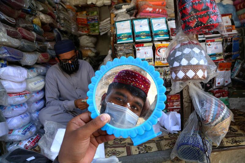 A man in Peshawar, Pakistan, tries on a traditional cap in preparation for Ramadan, the Muslim month of fasting. AP Photo