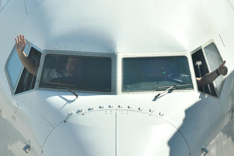 Pilots wave from the cockpit as they prepare to depart flying the first Qantas flight between Sydney and Adelaide since Covid-19 border restrictions were lifted, at Sydney Domestic Airport in Sydney, Australia. EPA