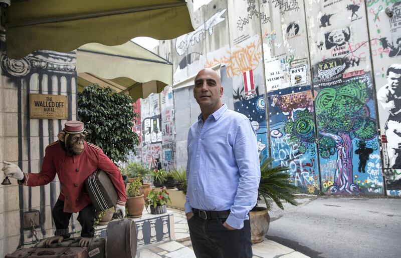 Wisam Salsa, the Walled-Off Hotel's Palestinian co-founder and manager as he stands outside the entrance .Salsa says, ÒItÕs given a massive boost to the Palestinian tourism industry.Ó (Photo by Heidi Levine for The National).