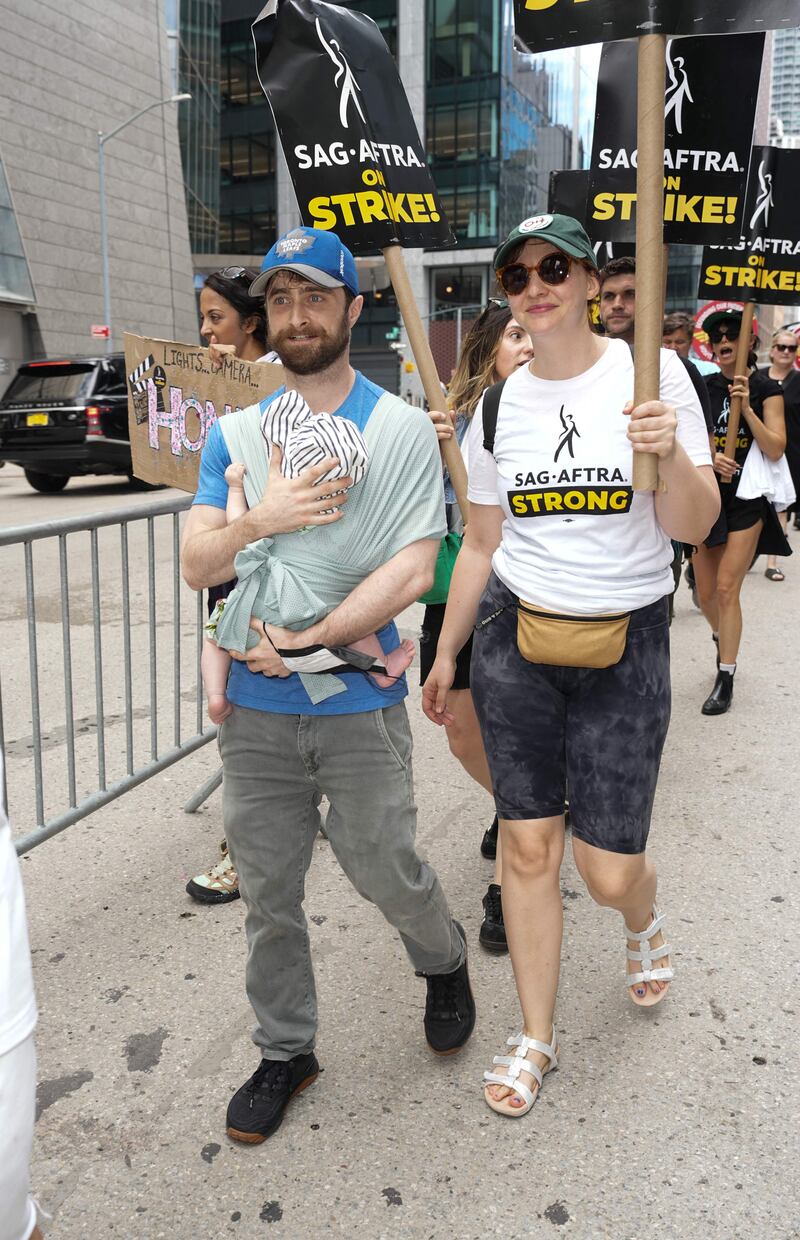 Daniel Radcliffe and girlfriend Erin Darke join the picket line in New York City. Getty Images