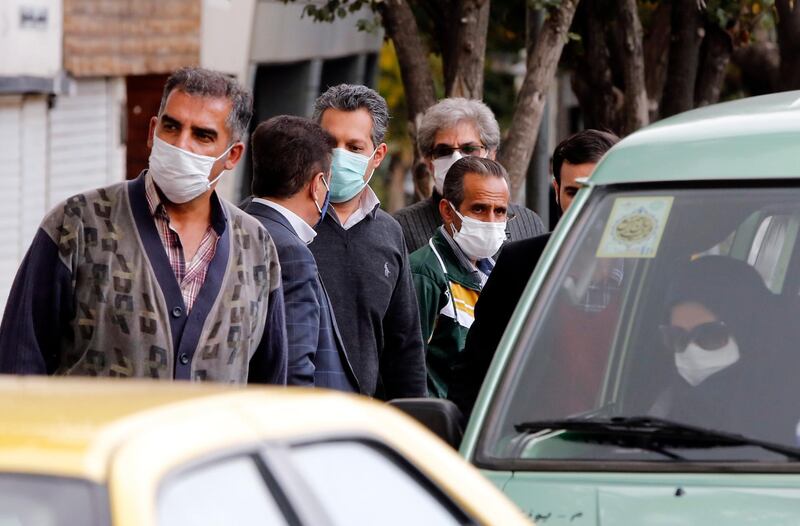 epa08820540 Iranians wearing face masks wait in a taxi line in a street in Tehran, Iran, 14 November 2020. According to the Iranian Health ministry, Iran reported its daily COVID-19 death toll and infections by announcing 452 deaths and 11,203 new infections in past 24 hours, in what appears to be a third wave of the COVID-19 outbreak. Iranian president Hassan Rouhani said on 14 November 2020 that his government will announce more lockdown next week over coronavirus crisis.  EPA/ABEDIN TAHERKENAREH