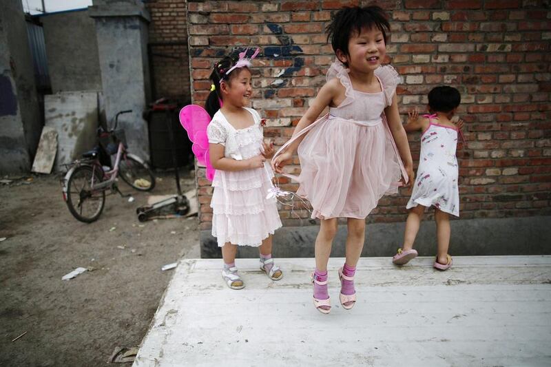 Children play on abandoned wood panels in Dongxiaokou village in Beijing. Kim Kyung-Hoon / Reuters