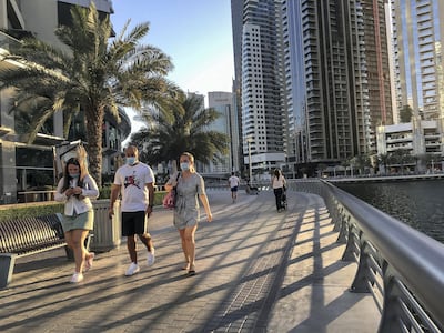 DUBAI, UNITED ARAB EMIRATES. 12 MAY 2020. Dubai residents exercise along the promenade in Dubai Marina (Photo: Antonie Robertson/The National) Journalist: None. Section: National.