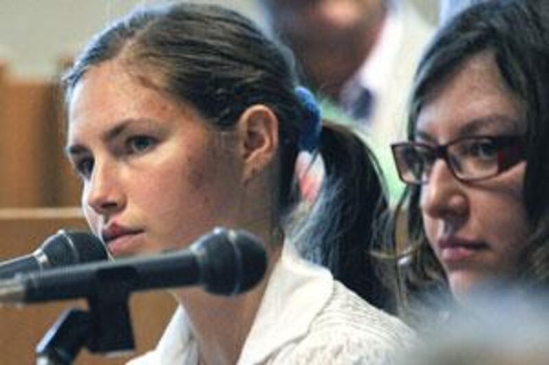 Amanda Knox, the jailed murder suspect, left, sits next to an interpreter in the court room.