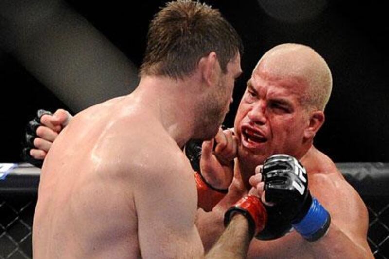 Tito Ortiz is rocked by a punch from Forrest Griffin in his retirement bout at UFC 148