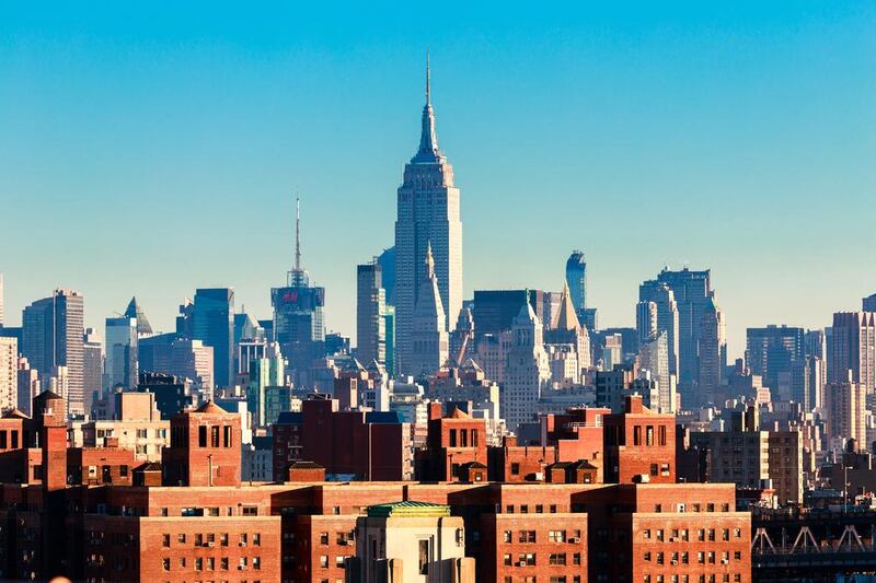 The New York City skyline with the Empire State Building, centre, seen rising above flats in the Lower East Side. Sascha Kilmer / Getty Images