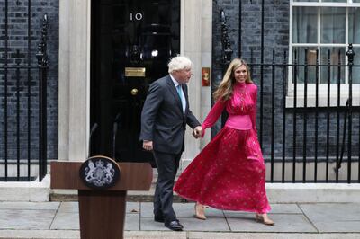 Boris Johnson and his wife Carrie Johnson outside No 10 Downing Street on Tuesday. AFP
