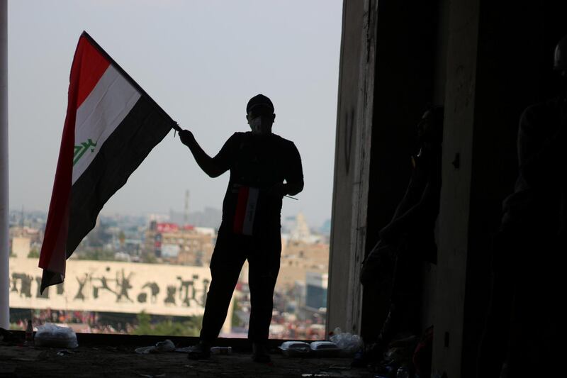 Mohamed al-Qaisy, 25, stands in the window of the Turkish restaurant building overlooking Tahrir Square. Pesha Magid