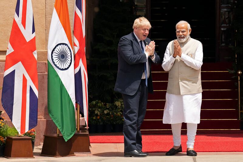 Britain's Prime Minister Boris Johnson (L) and his Indian counterpart Narendra Modi bond before their meeting at Hyderabad House in New Delhi. AFP