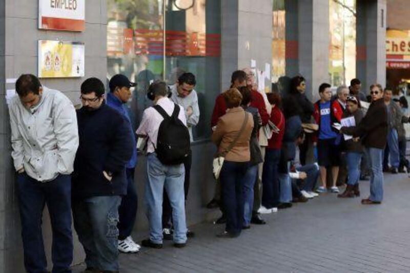 People queue to enter a government-run employment office in Madrid. Spain’s unemployment rate rose to a new record of 27.2 per cent in the first quarter of this year.