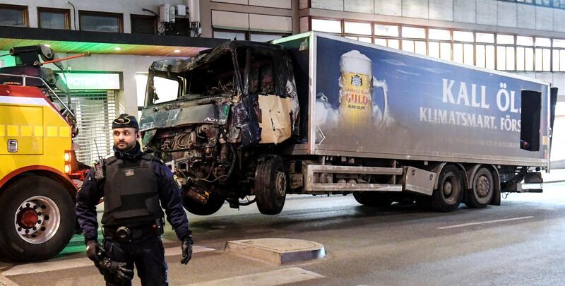 epa06520301 (FILE) - Tow trucks move the beer truck that crashed into the Ahlens department store after plowing down Drottninggatan Street in central Stockholm, Sweden, 08 April 2017 (re-issued 13 February 2018). Five people were killed and 15 injured in the suspected terror attack. The suspect, Uzbek asylum seeker Rakhmat Akilov went on trial in Stockholm on 13 February 2018 accused of terrorism. Akilov has pleaded guilty to charges and said he wanted to kill 'infidels'.  EPA/MAJA SUSLIN SWEDEN OUT