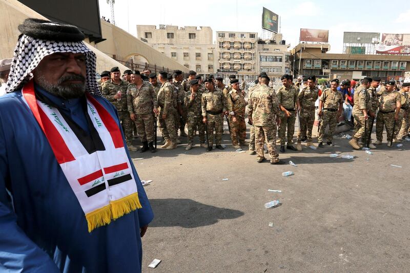 Iraqi policemen stand guard in central Baghdad.  EPA