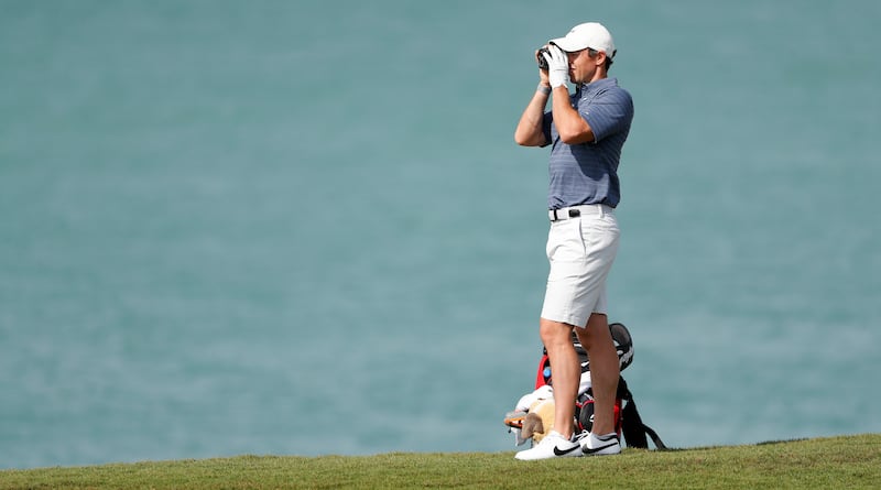 Rory McIlroy checks the yardage during a practice round prior to the Abu Dhabi HSBC Championship at Yas Links Golf Course. Getty