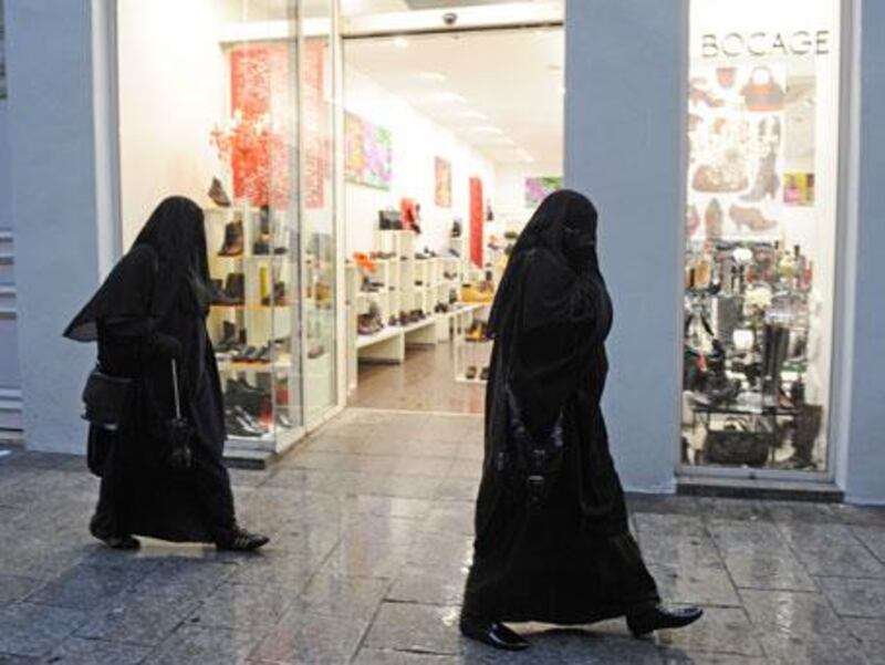 Women pictured in Marseilles on Christmas Eve wearing the full-length burqa.