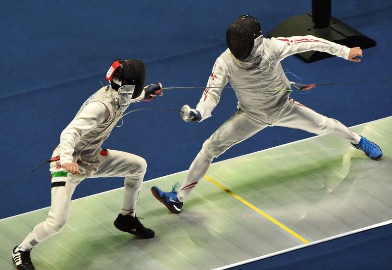 UAE's Majed Al Mansoori, left, lunges at Japan's Yuki Ota, right, in the men's fencing foil quarter-finals on Monday at the 2014 Asian Games in Incheon, South Korea. Roslan Rahman / AFP / September 22, 2014