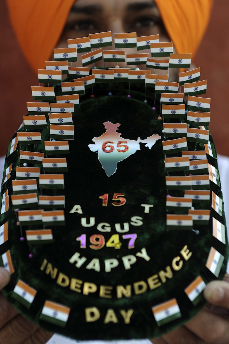Indian artist Harwinder Singh Gill displays a miniature stadium model featuring 65 Indian national flags and a map of India on the eve of India's  64th Independence Day celebrations, in Amritsar on August 14, 2011.  India celebrates its independence from British rule in 1947 on August 15. AFP PHOTO/NARINDER NANU
 *** Local Caption ***  610060-01-08.jpg