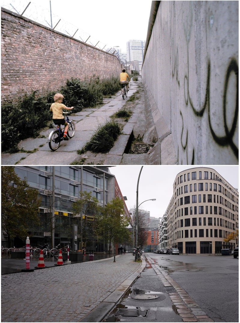 This combination of photos shows a father and son, top, riding their bicycles along a section of the Berlin Wall in Berlin on July 1981 and the same location in November, 2019. AP Photo