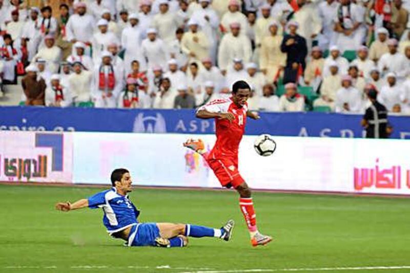 Ahmed Khalil, right, the UAE's goalscorer, evades a Kuwait challenge last night.
