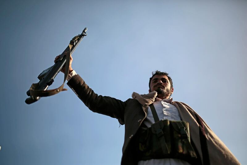 A Houthi supporter holds his weapon during a demonstration against the United States over its decision to designate the Houthis a foreign terrorist organization in Sanaa, Yemen. AP