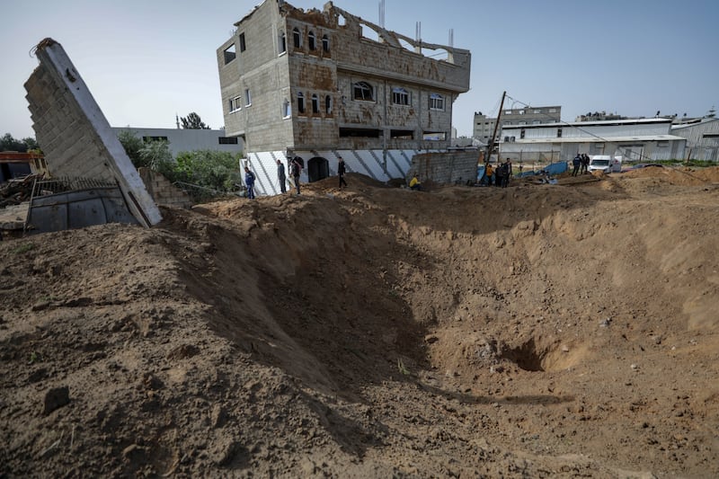 Palestinians inspect the damage after Israeli air strikes in Gaza City. EPA