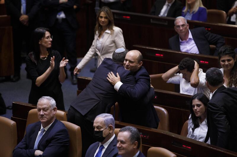 Naftali Bennett, Israeli's new prime minister and leader of the Yamina party, embraces an attendee at the Knesset in Jerusalem, Israel. Bloomberg