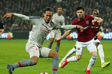 Liverpool's Virgil van Dijk, left, in action with West Ham's Aaron Cresswell at the London Stadium. Reuters