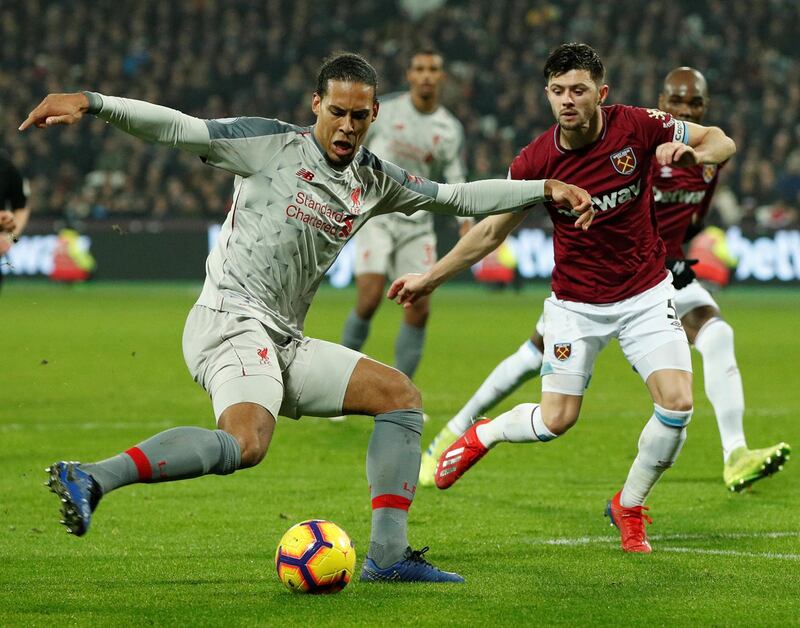 Soccer Football - Premier League - West Ham United v Liverpool - London Stadium, London, Britain - February 4, 2019  Liverpool's Virgil van Dijk in action with West Ham's Aaron Cresswell               Action Images via Reuters/John Sibley  EDITORIAL USE ONLY. No use with unauthorized audio, video, data, fixture lists, club/league logos or "live" services. Online in-match use limited to 75 images, no video emulation. No use in betting, games or single club/league/player publications.  Please contact your account representative for further details.