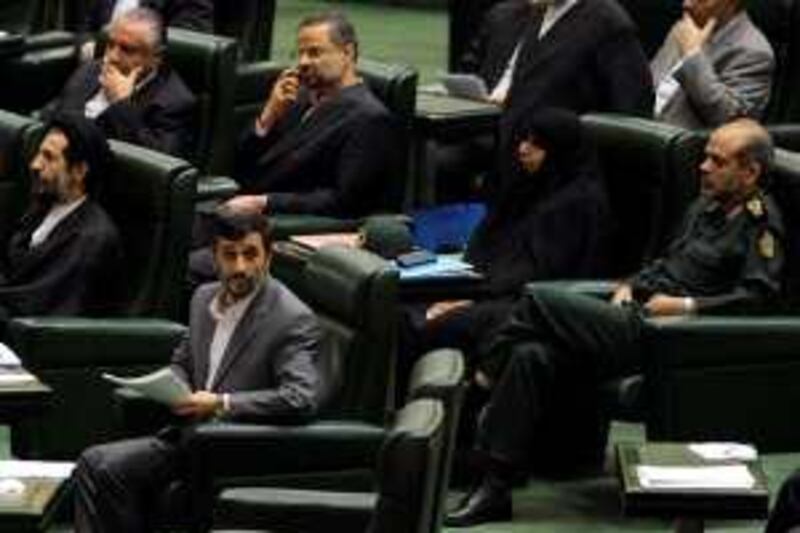 Iranian President Mahmoud Ahmadinejad (front R), first deputy parliament speaker, Hasan Abutorabifard (front L), nominee for transport minister Hamid Behbahani (top L), nominee for labour minister Abdolreza Sheikholeslami (top 2nd-L), nominee for education minister Sousan Keshavarz (2nd-R), and nominee for defence minister Ahmad Vahidi (R) attend a parliament session in Tehran on August 30, 2009. Embattled Ahmadinejad, whose disputed re-election unleashed the worst crisis in the Islamic republic's history, appealed to parliament to approve his new cabinet at the start of a three-day debateahead of a vote of confidence on September 2. AFP PHOTO/BEHROUZ MEHRI *** Local Caption ***  691393-01-08.jpg