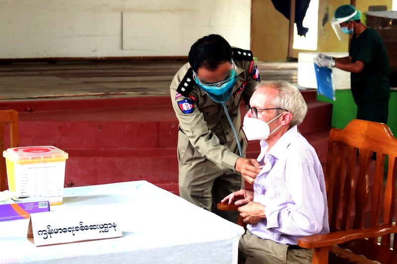 Sean Turnell, a detained Australian who has been charged with breaching Myanmar's official secrets law, receives a Covid-19 vaccine does at the Insein prison in Yangon. Myanmar News Agency via AFP